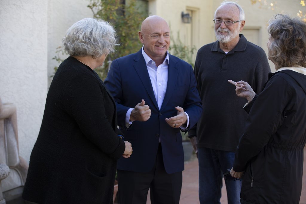 Mark Kelly laughs while speaking with several Arizona seniors.