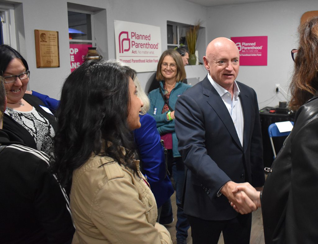 Mark Kelly shakes hand with Planned Parenthood advocates.